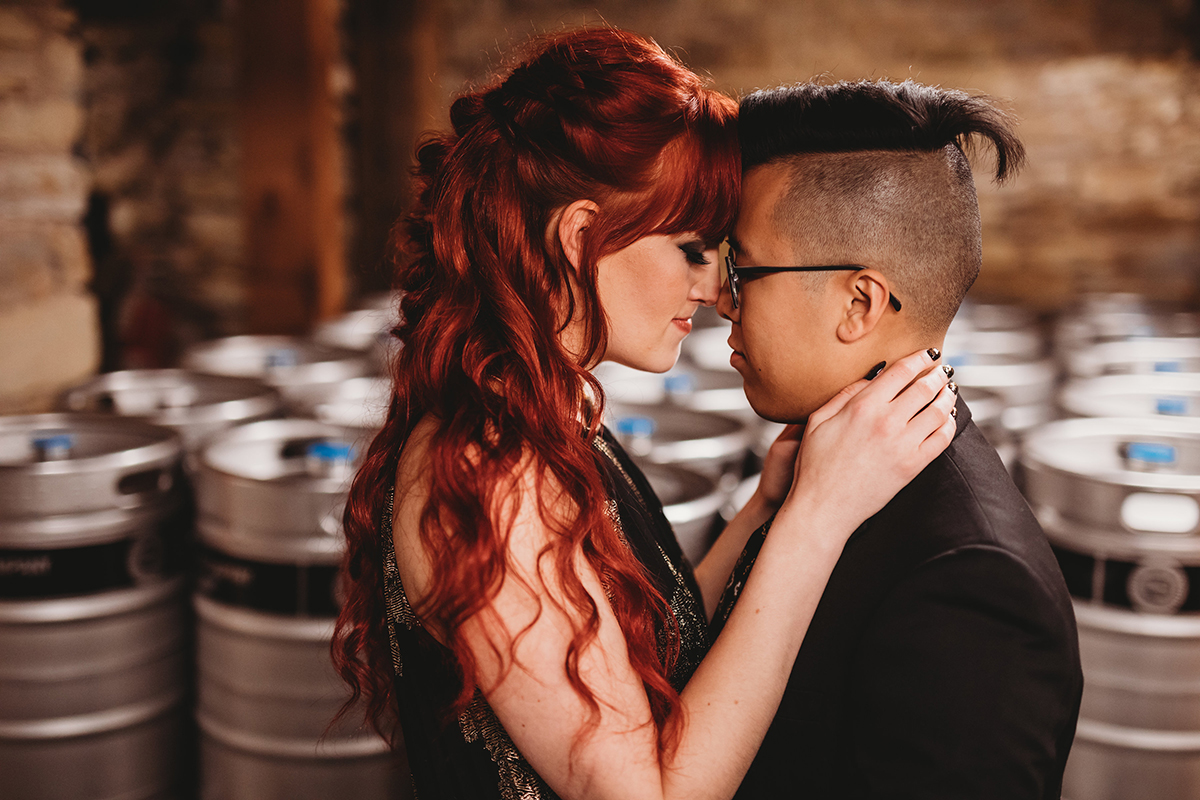 closeup Alyssa & Nick in front of kegs